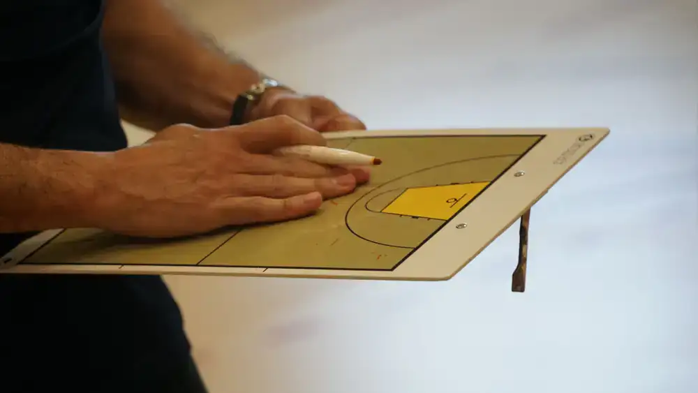 Coach drawing strategy lines on a game map