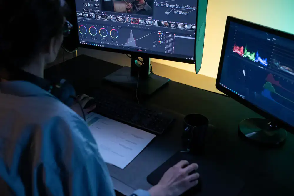 Student and coach analyzing gameplay footage on dual monitors